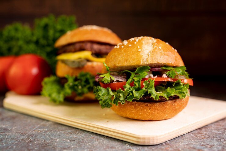 close-up-hamburgers-cutting-board_23-2148262994